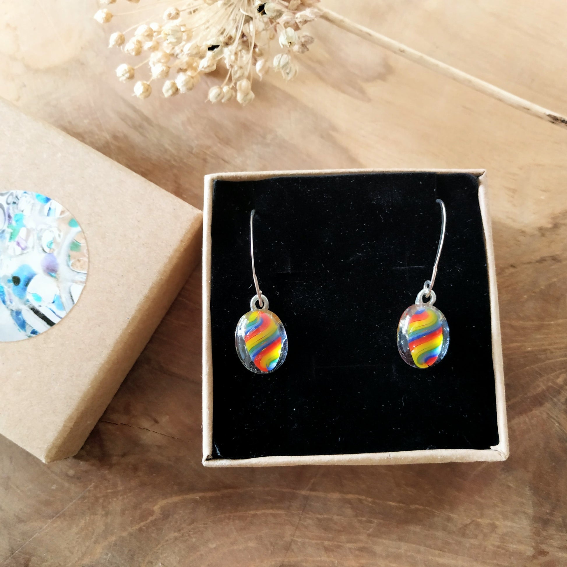 Rainbow earrings in open box . handmade by Pamela Angus 