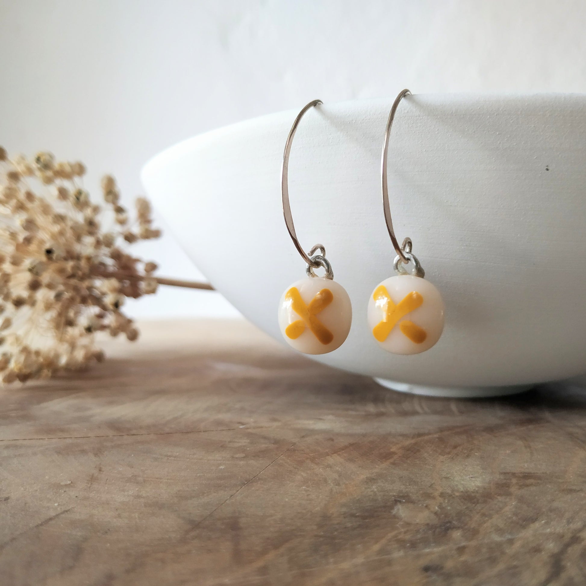 Cream glass with yellow ochre x  and silver  ear wires