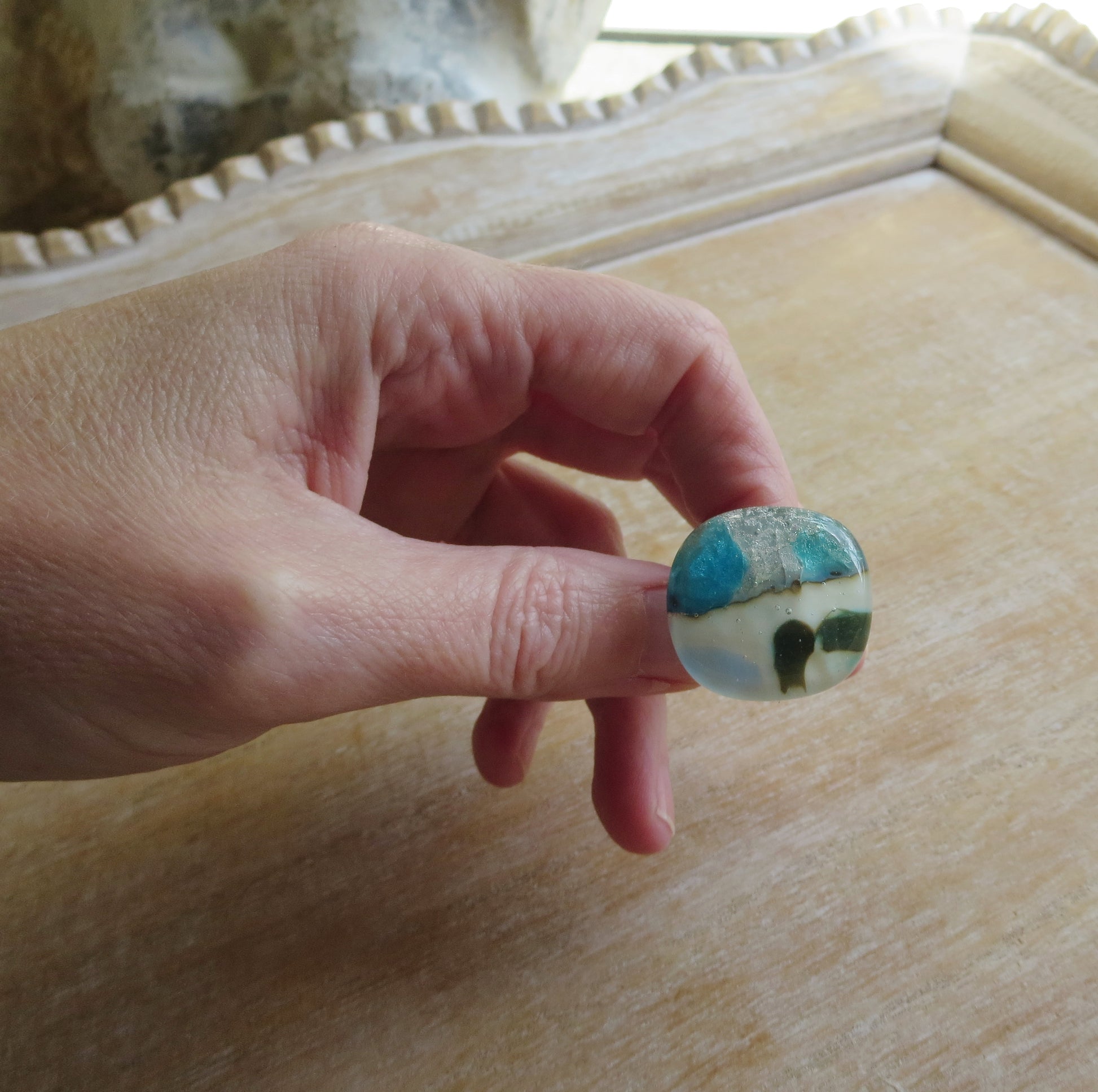 Hand holding fused glass ring by Pamela Angus